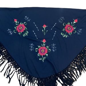 Black shawl wrap with embroidered flowers and crocheted fringe on the border